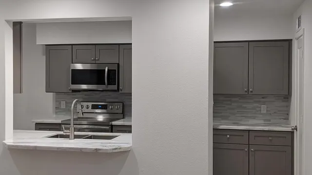a kitchen with a sink and a microwave