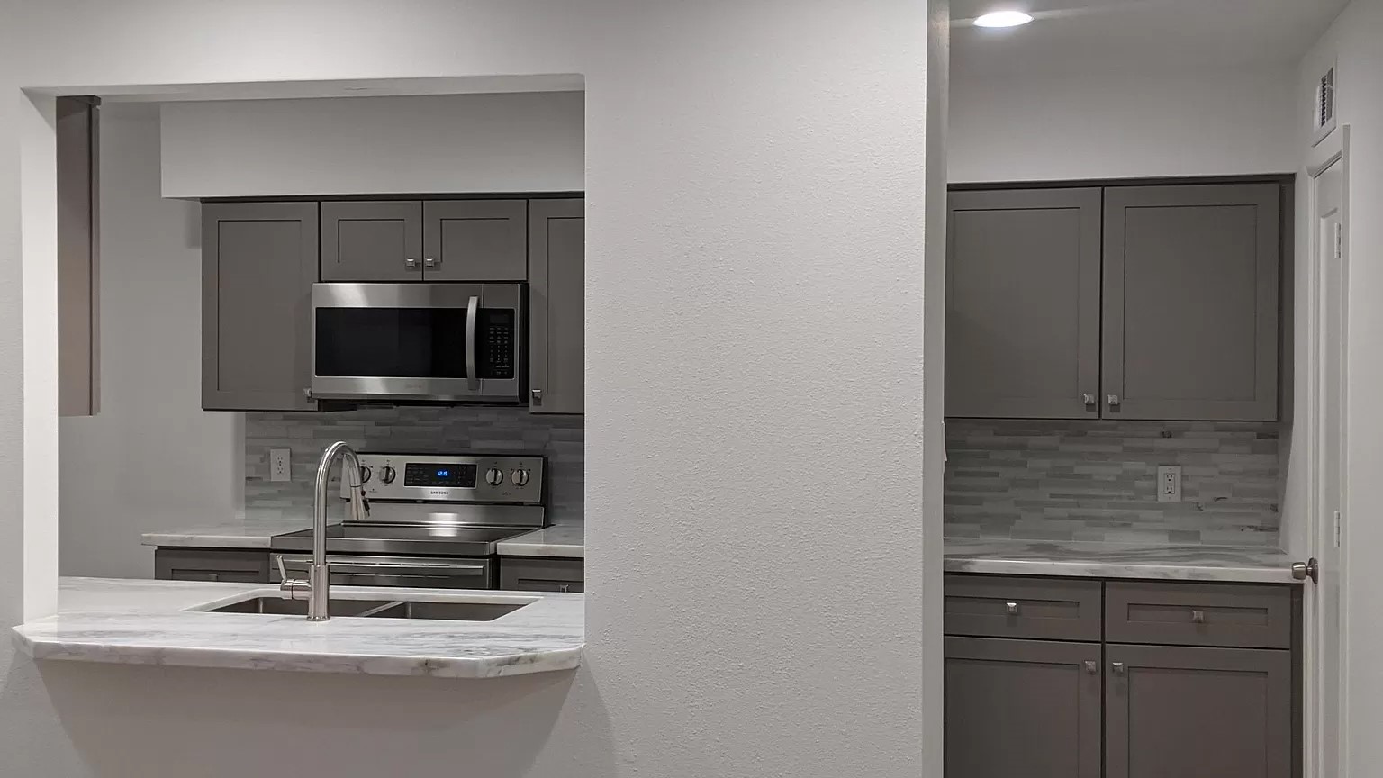 5528 Beverly Hill Street, Unit 3 Houston, TX 77056 - Photo 24 of 50 a kitchen with a sink and a microwave