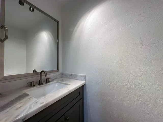 a bathroom with a sink and vanity