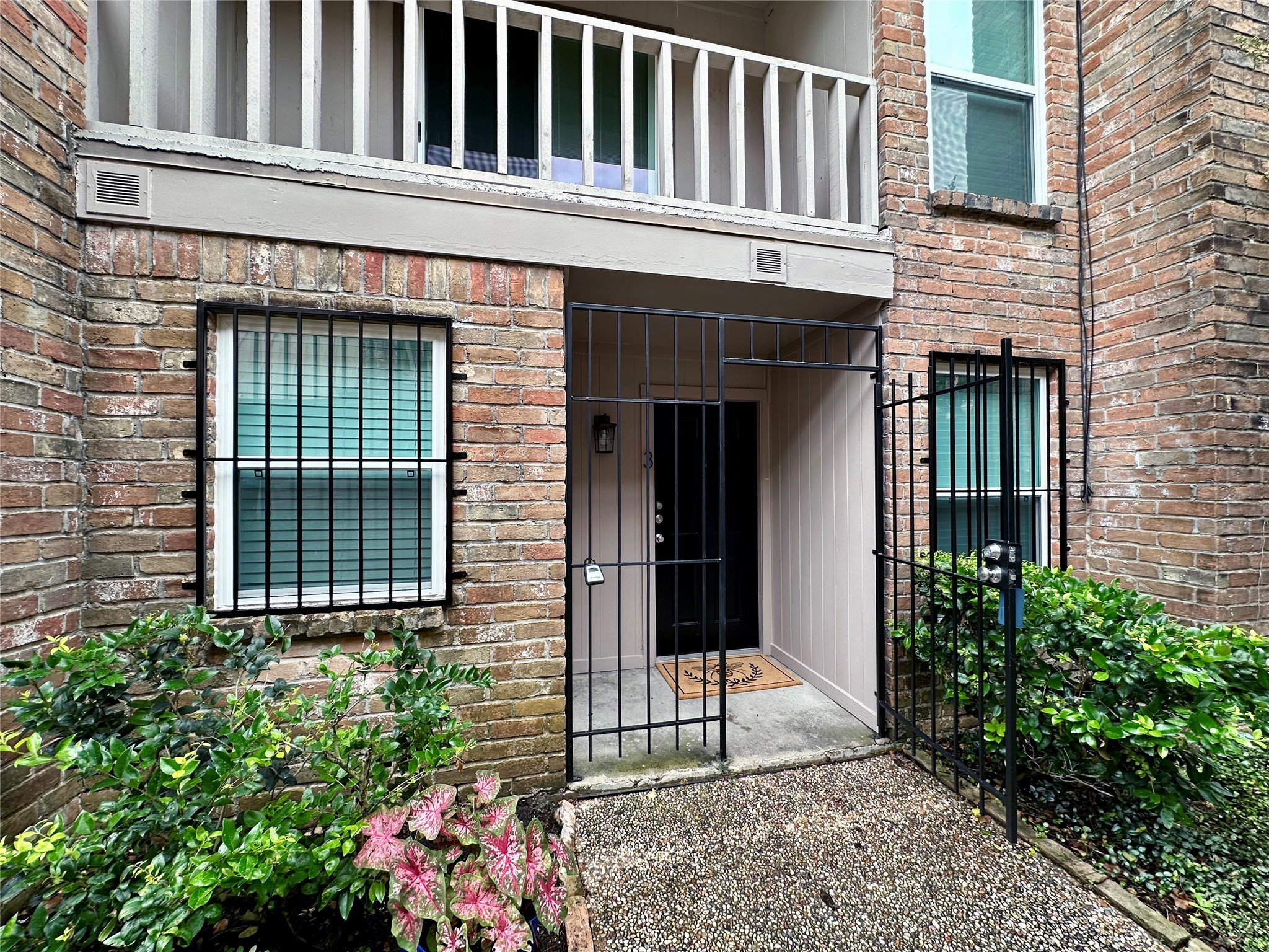 5528 Beverly Hill Street, Unit 3 Houston, TX 77056 - Photo 3 of 50 a view of a house with potted plants and a chair