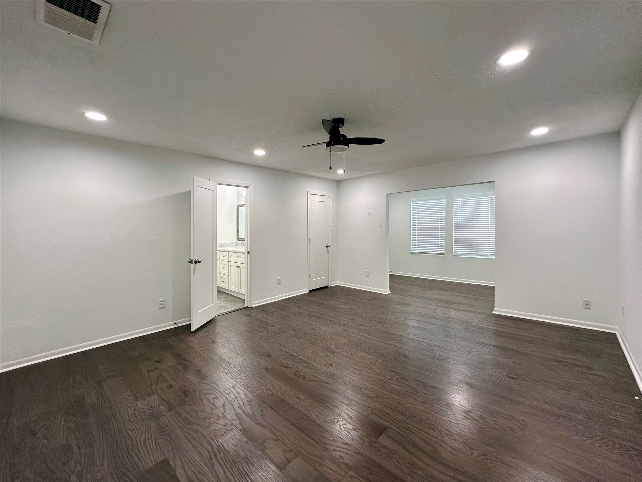 5528 Beverly Hill Street, Unit 3 Houston, TX 77056 - Photo 32 of 50 an empty room with wooden floor and windows