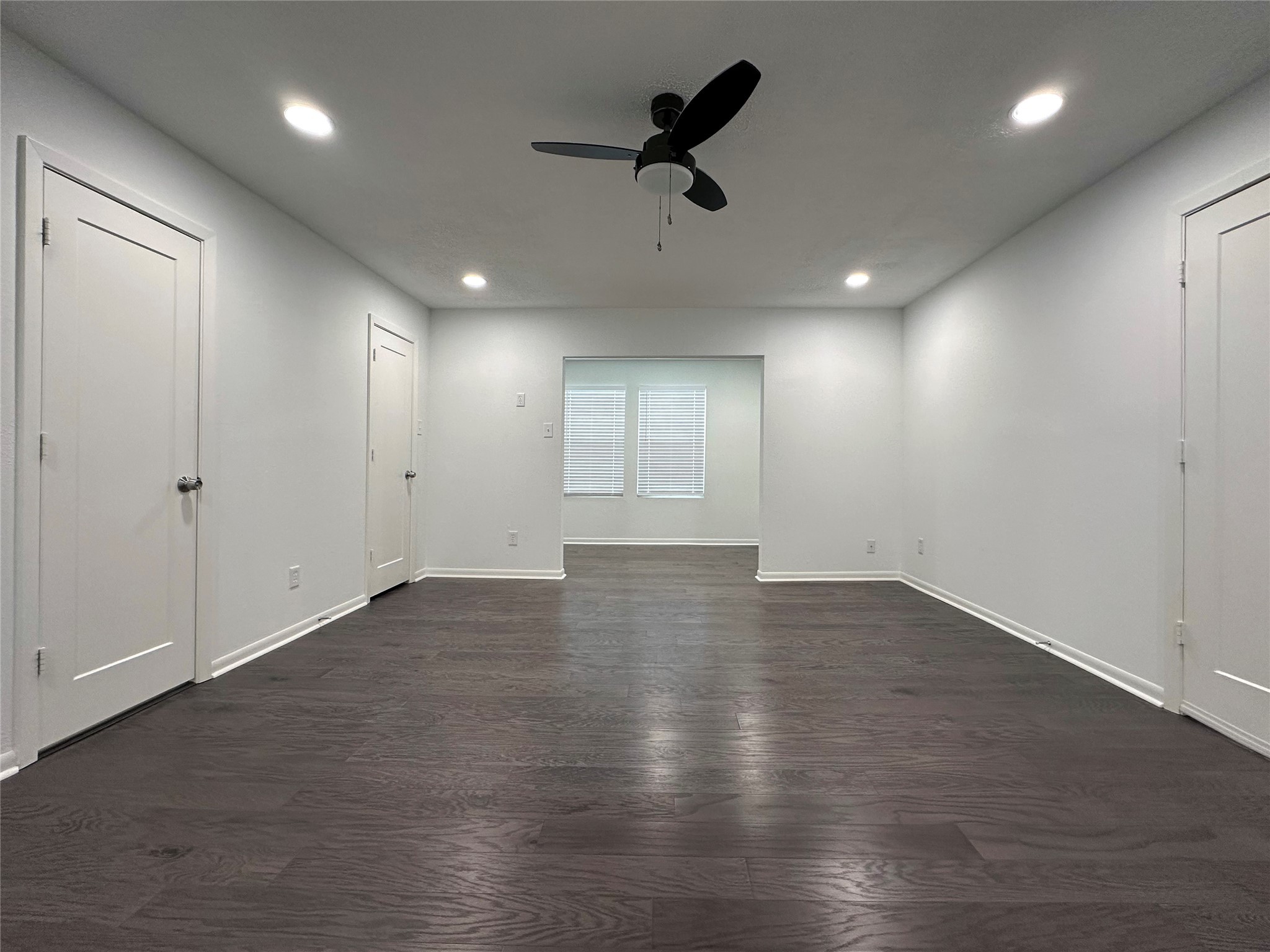 5528 Beverly Hill Street, Unit 3 Houston, TX 77056 - Photo 33 of 50 an empty room with wooden floor and windows