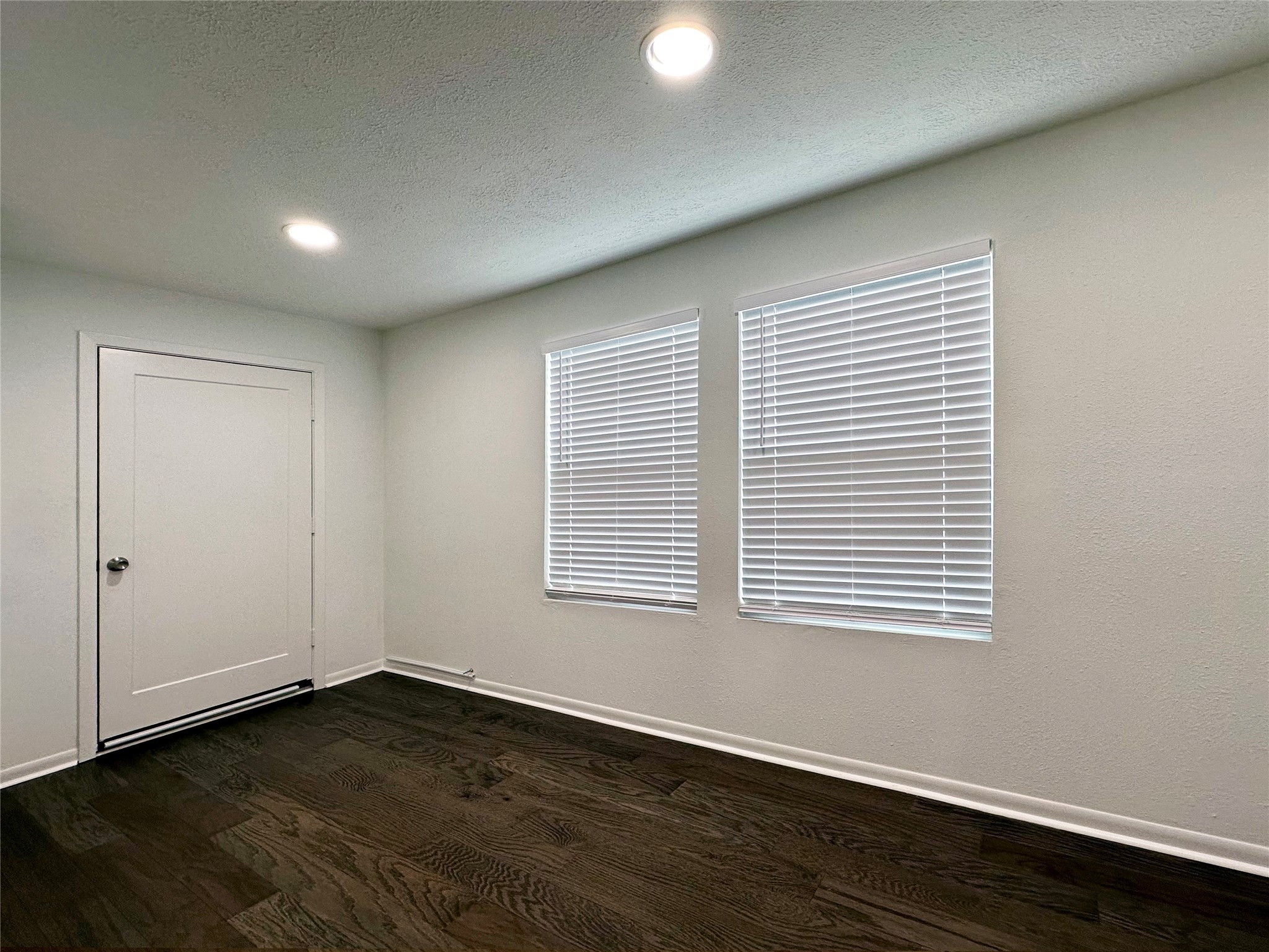5528 Beverly Hill Street, Unit 3 Houston, TX 77056 - Photo 36 of 50 an empty room with wooden floor and windows