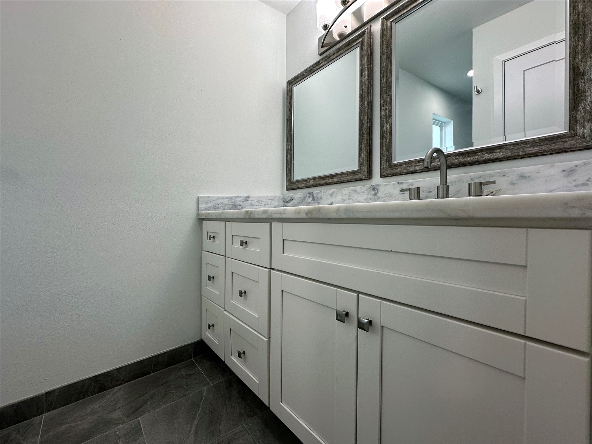 5528 Beverly Hill Street, Unit 3 Houston, TX 77056 - Photo 39 of 50 a bathroom with a granite countertop sink and a mirror