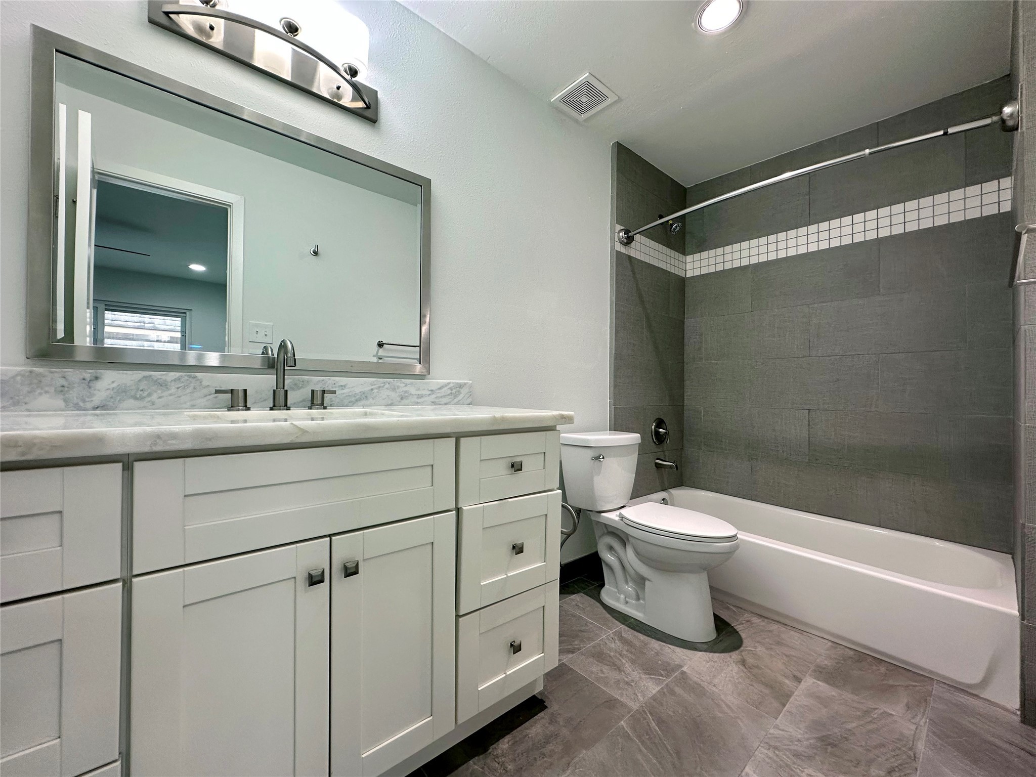 5528 Beverly Hill Street, Unit 3 Houston, TX 77056 - Photo 45 of 50 a bathroom with a double vanity sink toilet and shower
