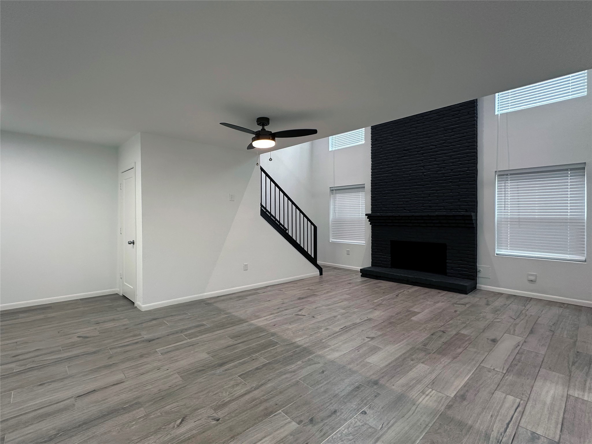 5528 Beverly Hill Street, Unit 3 Houston, TX 77056 - Photo 6 of 50 a view of an empty room with wooden floor and stairs