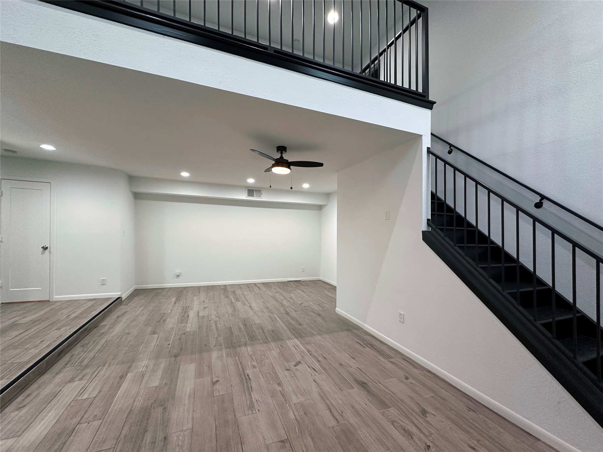 5528 Beverly Hill Street, Unit 3 Houston, TX 77056 - Photo 7 of 50 a view of an empty room with wooden floor