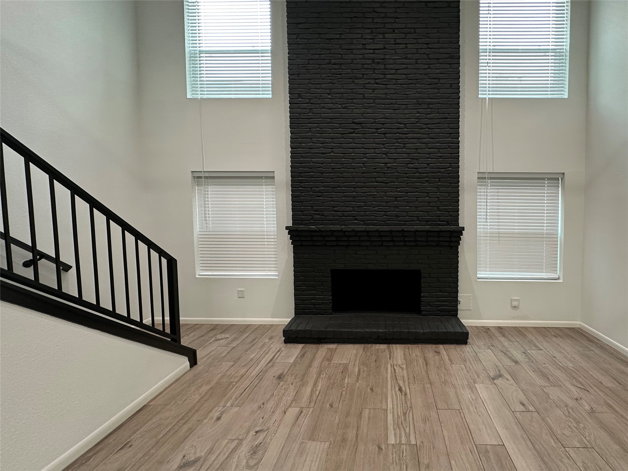 5528 Beverly Hill Street, Unit 3 Houston, TX 77056 - Photo 8 of 50 a view of a livingroom with wooden floor and staircase