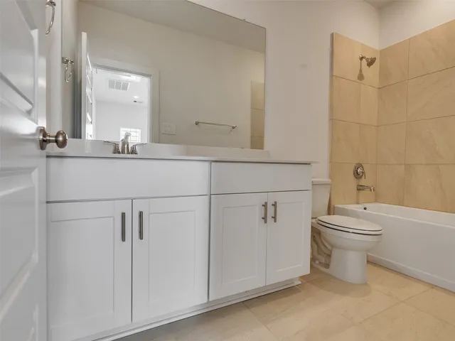a bathroom with a toilet a sink and bathtub
