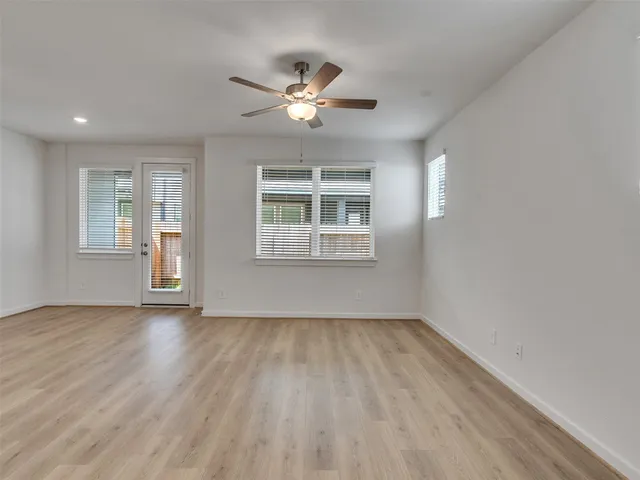 a large white kitchen with stainless steel appliances