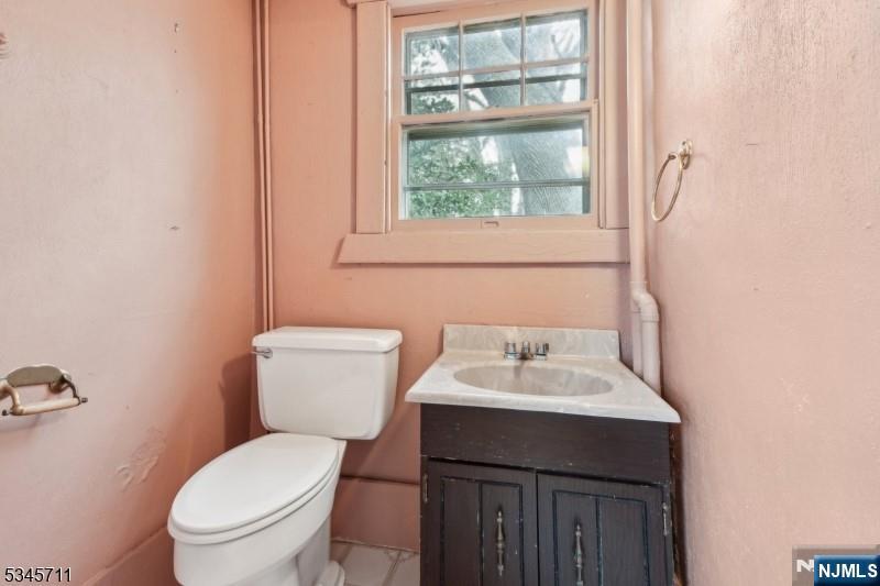 60 Berkeley Avenue Bloomfield, NJ 07003 - Photo 13 of 17 a bathroom with a sink toilet and a mirror