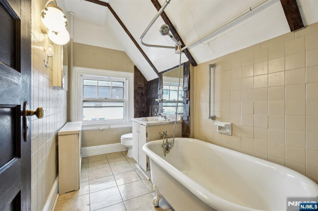 60 Berkeley Avenue Bloomfield, NJ 07003 - Photo 14 of 17 a bathroom with a bathtub a toilet and a shower