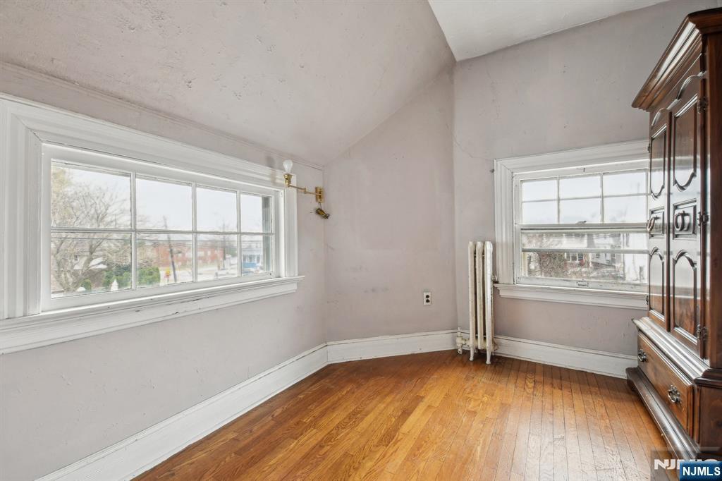 60 Berkeley Avenue Bloomfield, NJ 07003 - Photo 9 of 17 an empty room with wooden floor and windows