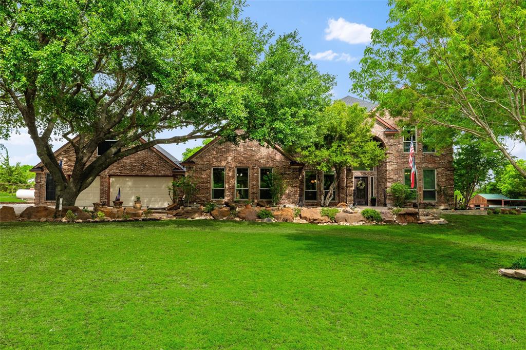 1820 Winningkoff Road Lucas, TX 75002 - Photo 2 of 40 Stone and brick facade residence with a prominent two-story entry