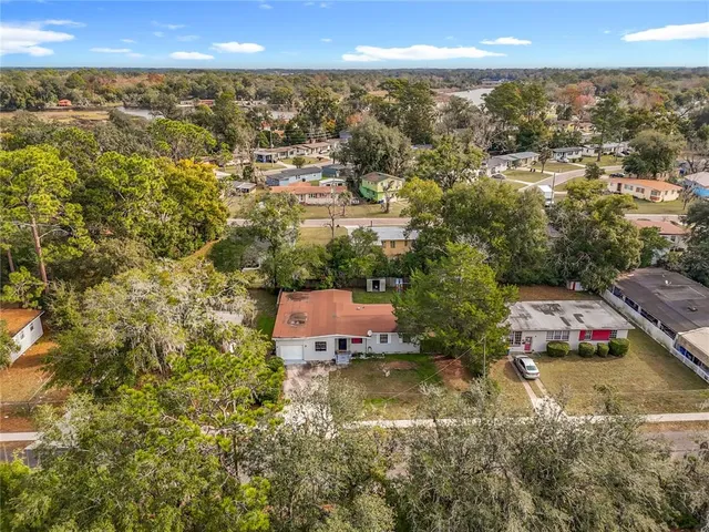 an aerial view of residential houses with yard and swimming pool
