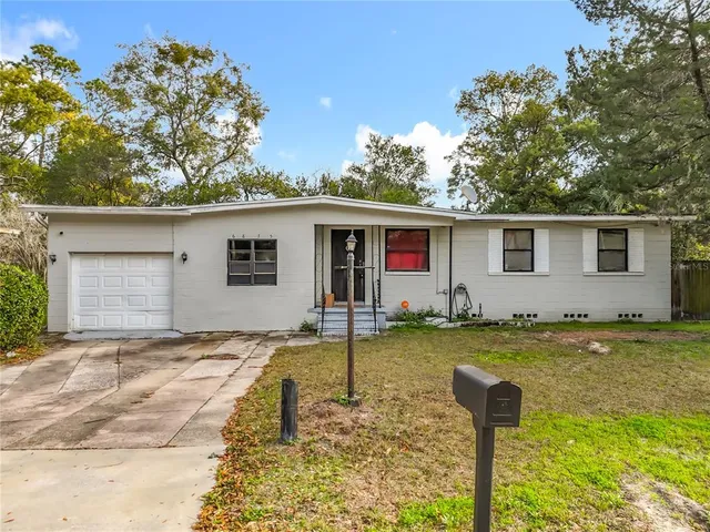 a front view of house with yard swimming pool and outdoor seating