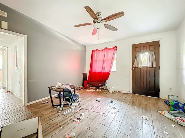 a workspace with wooden floor and furniture