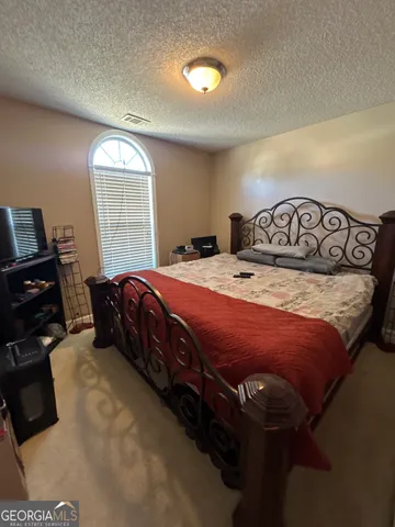 a bedroom with a bed and a tv