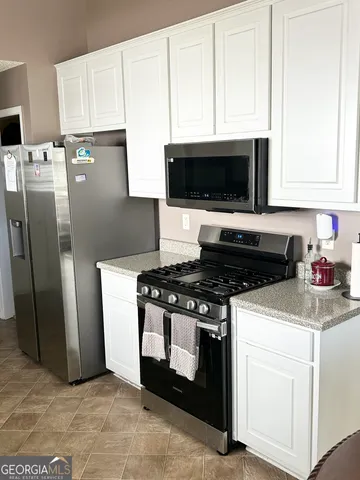 a kitchen with a stove and a microwave