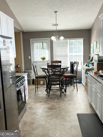 a view of a dining room with furniture window and outside view