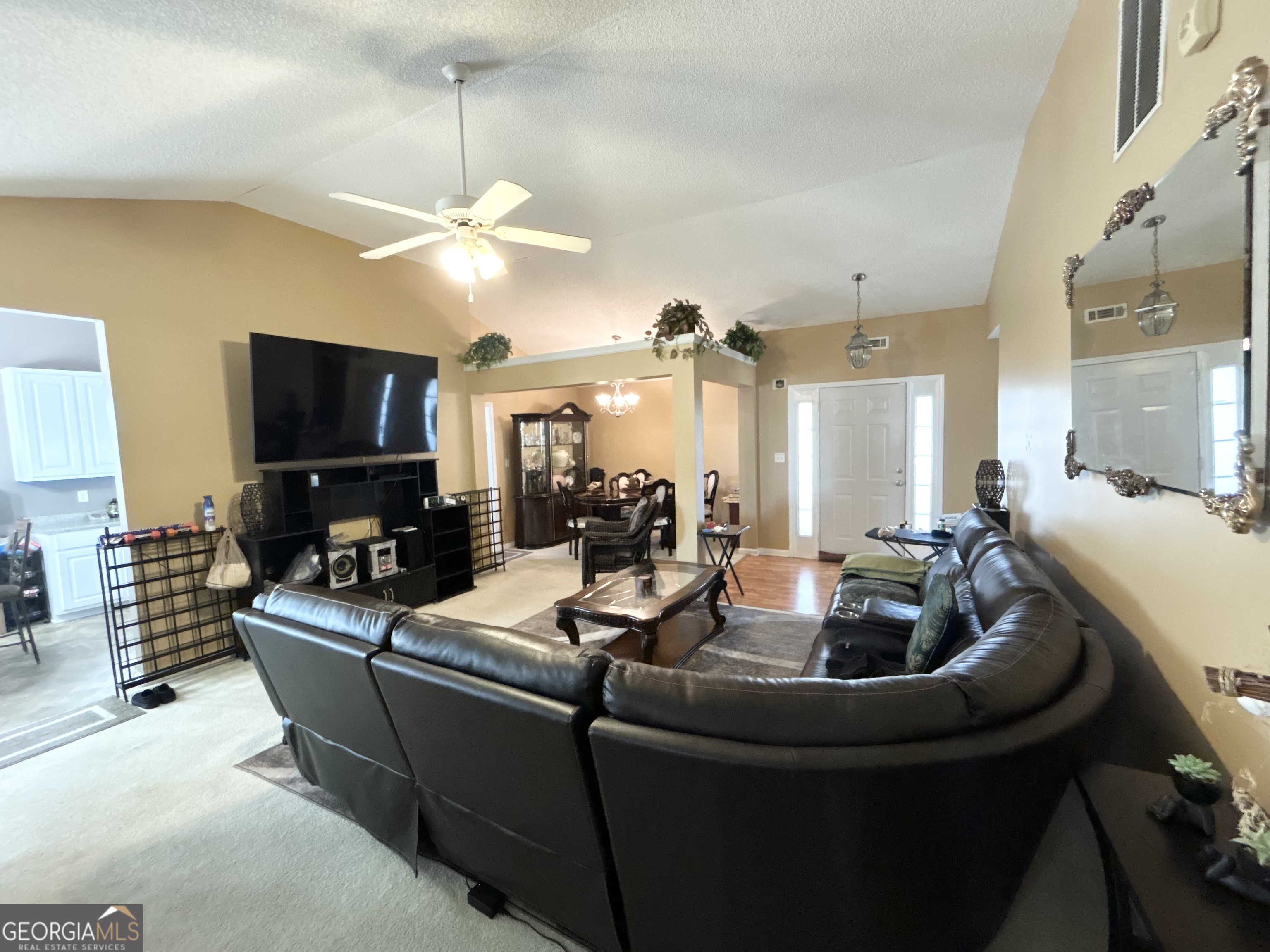 4889 Ozment Ridge Court Lithonia, GA 30038 - Photo 6 of 16 a living room with furniture and a flat screen tv