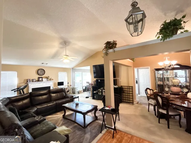 a living room with furniture a rug and a chandelier