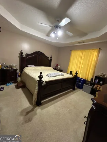 a bedroom with a bed and a lamp