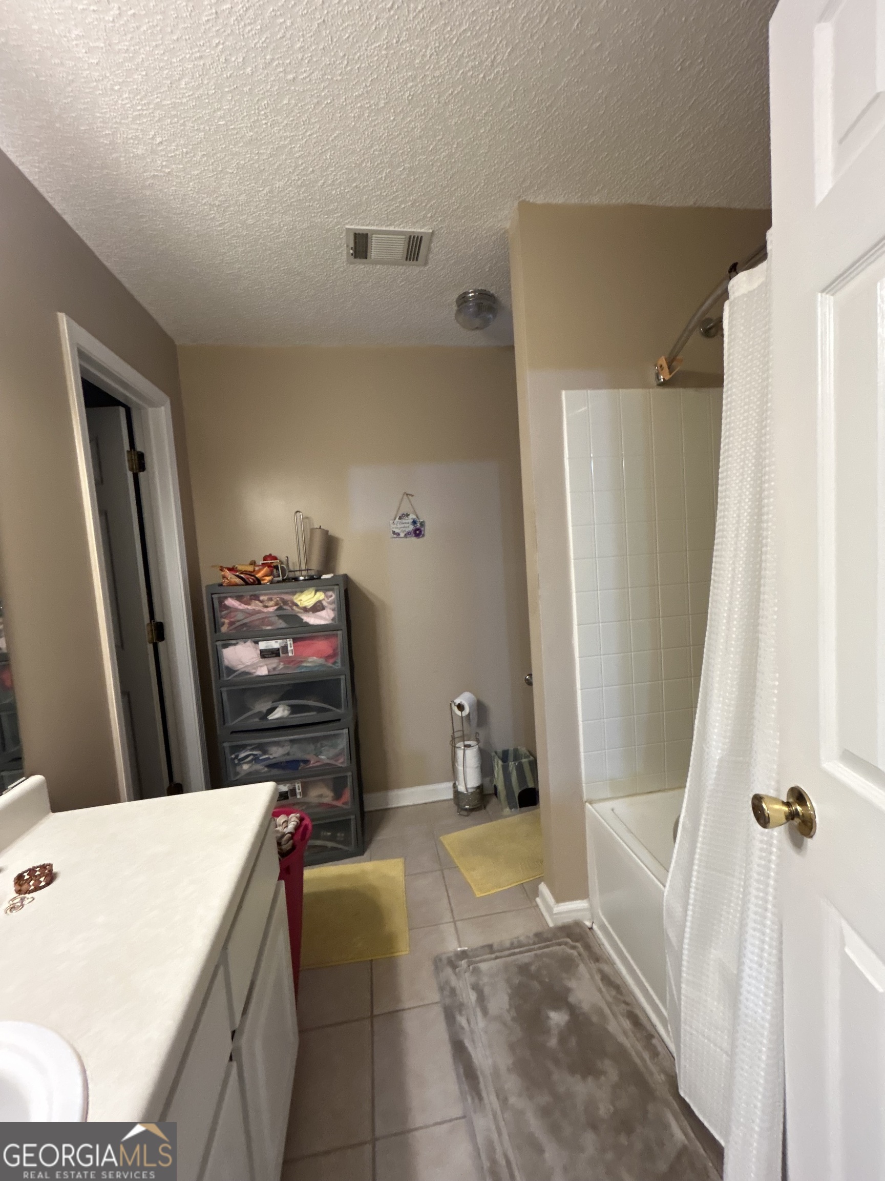 4889 Ozment Ridge Court Lithonia, GA 30038 - Photo 10 of 16 a bath room with a sink a washer and dryer