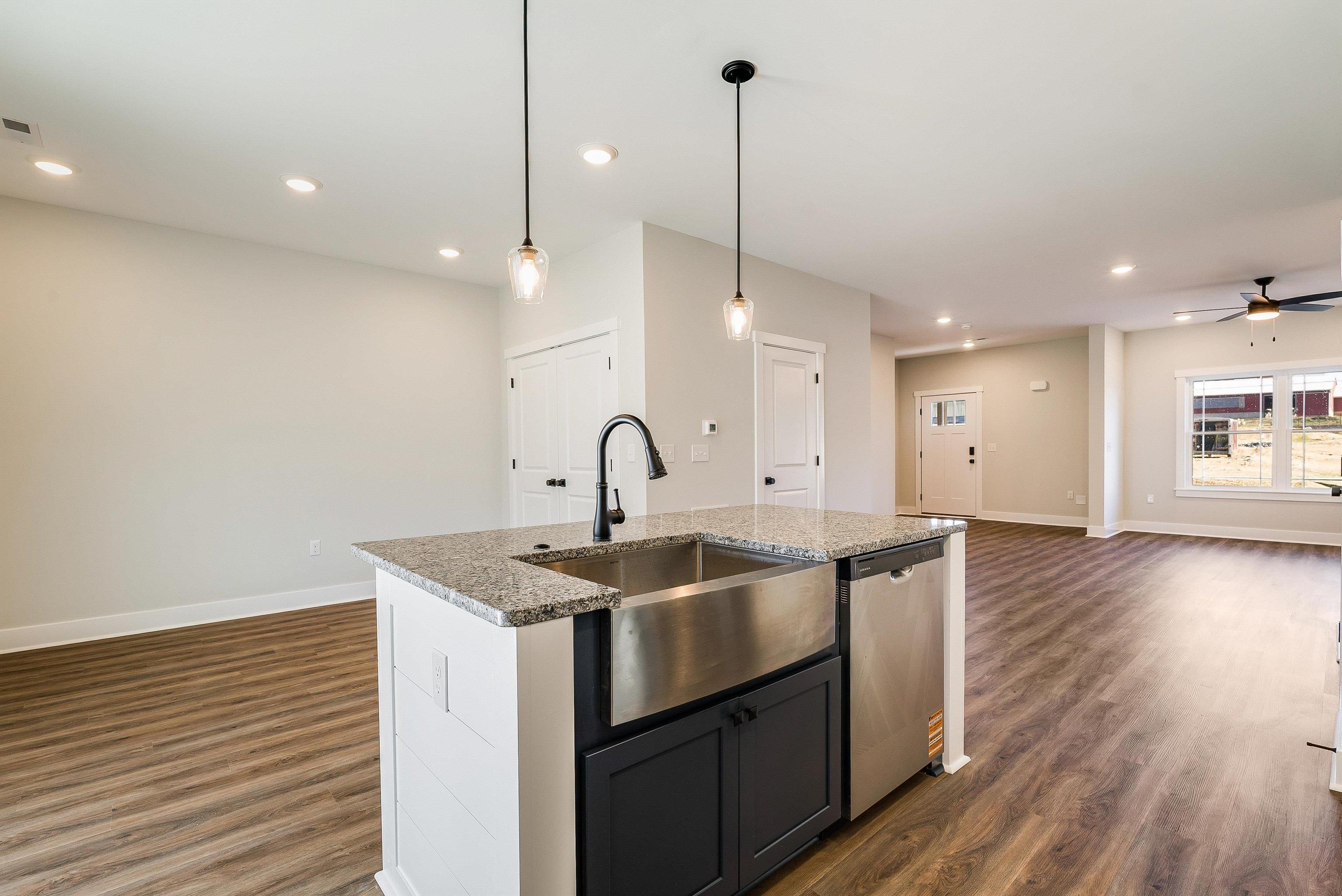 17 Barnyard Circle Bridgewater, VA 22812 - Photo 14 of 74 a kitchen with stainless steel appliances granite countertop a sink a window and wooden floor
