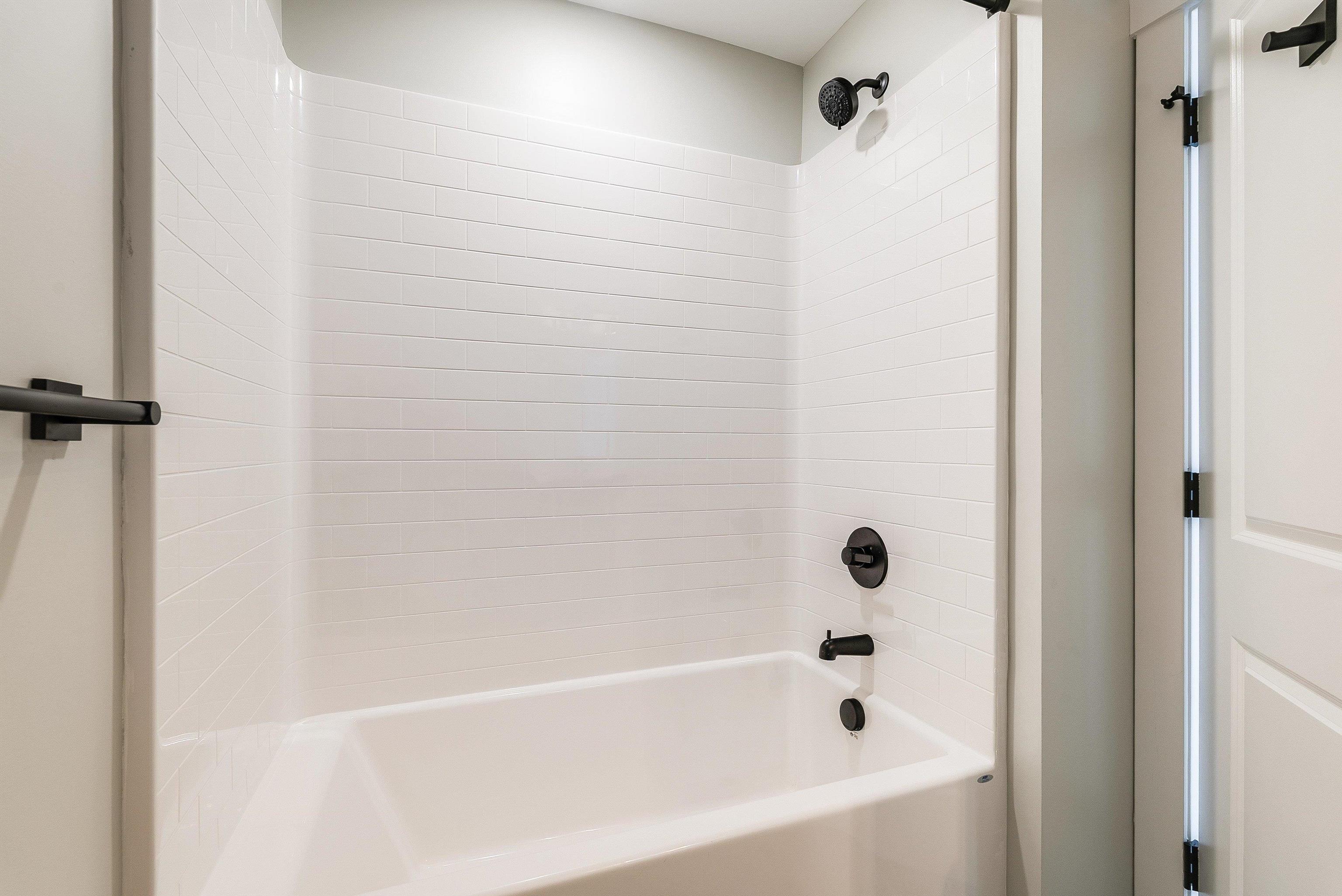 17 Barnyard Circle Bridgewater, VA 22812 - Photo 40 of 74 2nd full bath upstairs in the hallway features a large single vanity, tub/shower combo, and black plumbing fixtures.