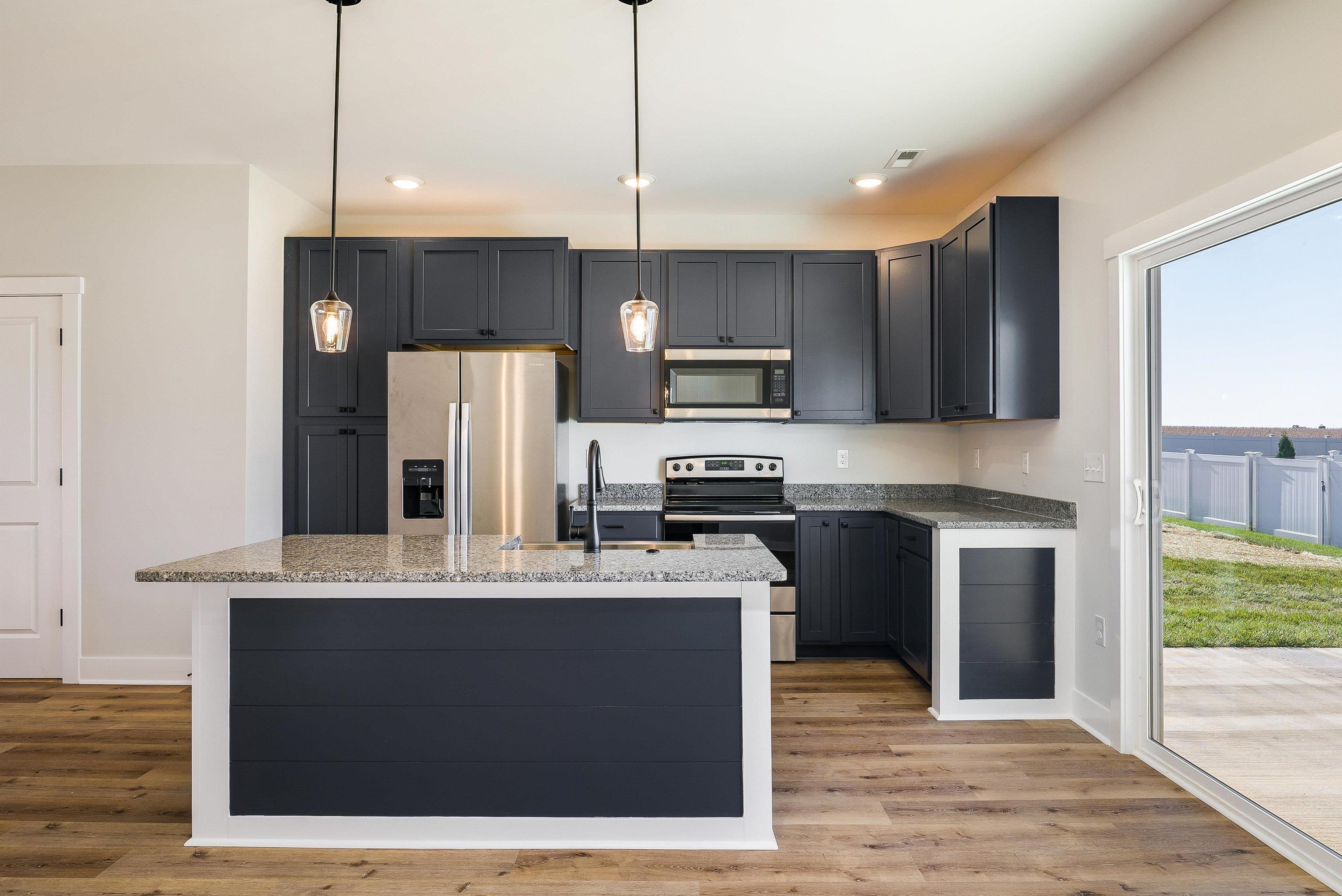 17 Barnyard Circle Bridgewater, VA 22812 - Photo 68 of 74 a kitchen with kitchen island granite countertop a sink a counter top space stainless steel appliances and cabinets