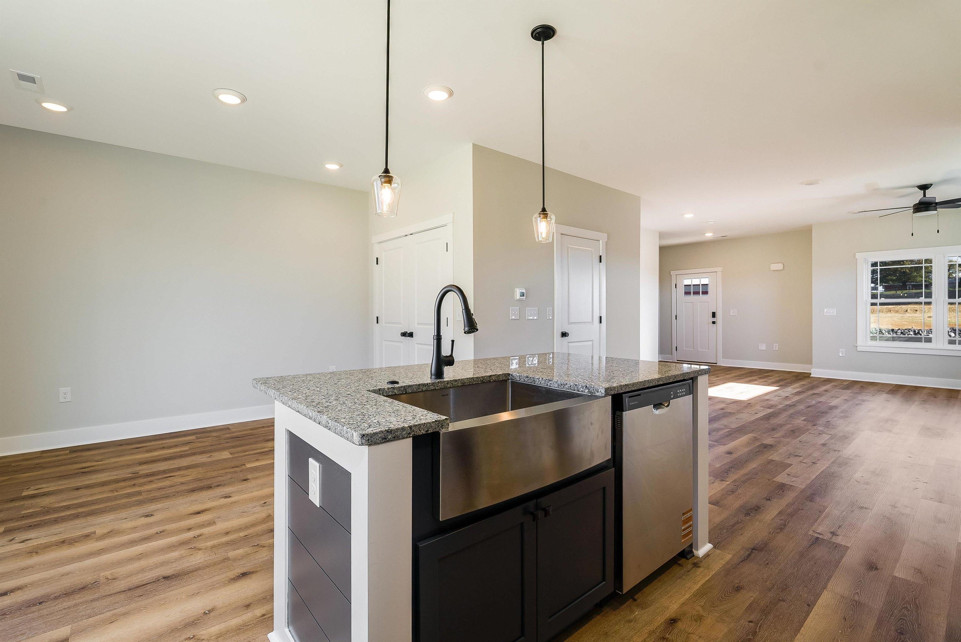 17 Barnyard Circle Bridgewater, VA 22812 - Photo 71 of 74 a kitchen with stainless steel appliances granite countertop a sink a stove and a wooden floor