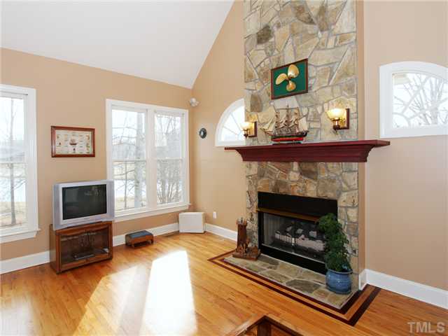 405 Normandy Road Louisburg, NC 27549 - Photo 3 of 22 Cathedral ceilings & a beautiful stone foreplace make the family room a favorite place to be.