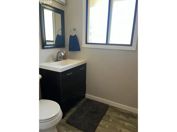 a bathroom with a sink a toilet and a mirror