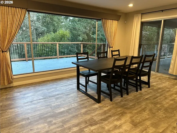 a view of a porch with furniture and wooden floor