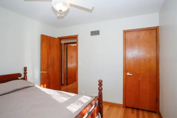 a bedroom with a bed and a dresser