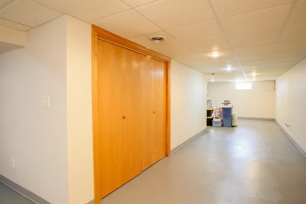 a view of a big room with wooden floor and a cabinet