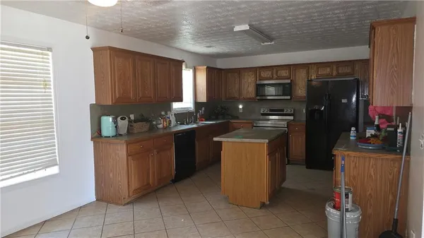 a kitchen with a refrigerator and a stove