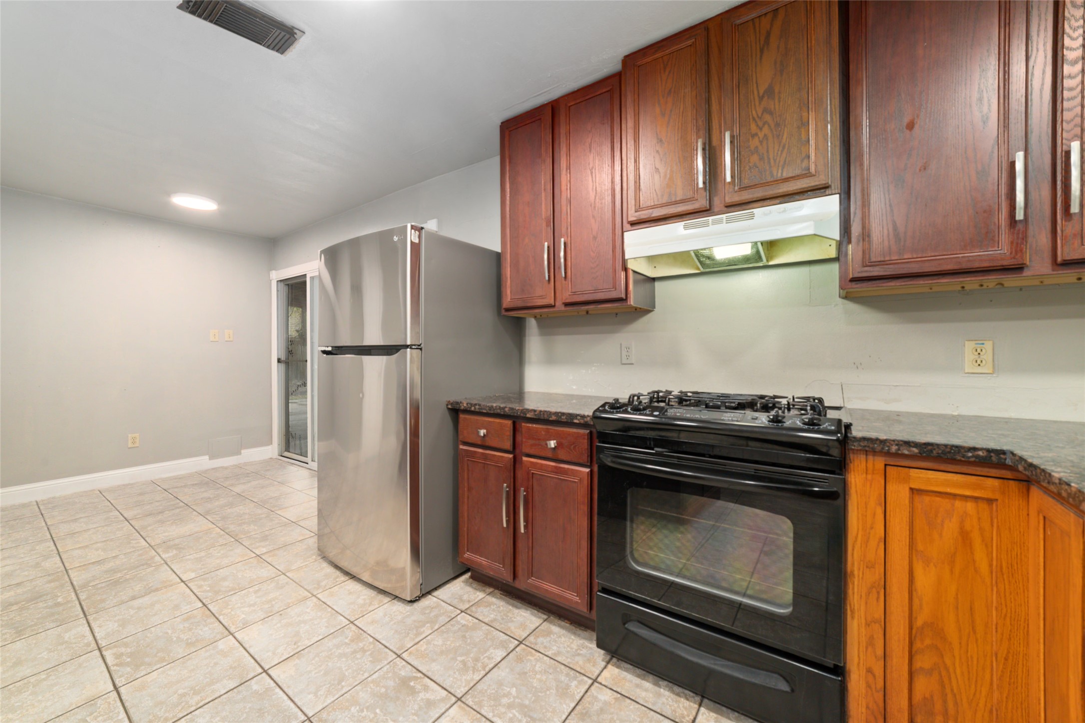 2318 Gum Spring Lane Spring, TX 77373 - Photo 11 of 25 a kitchen with a stove top oven and refrigerator