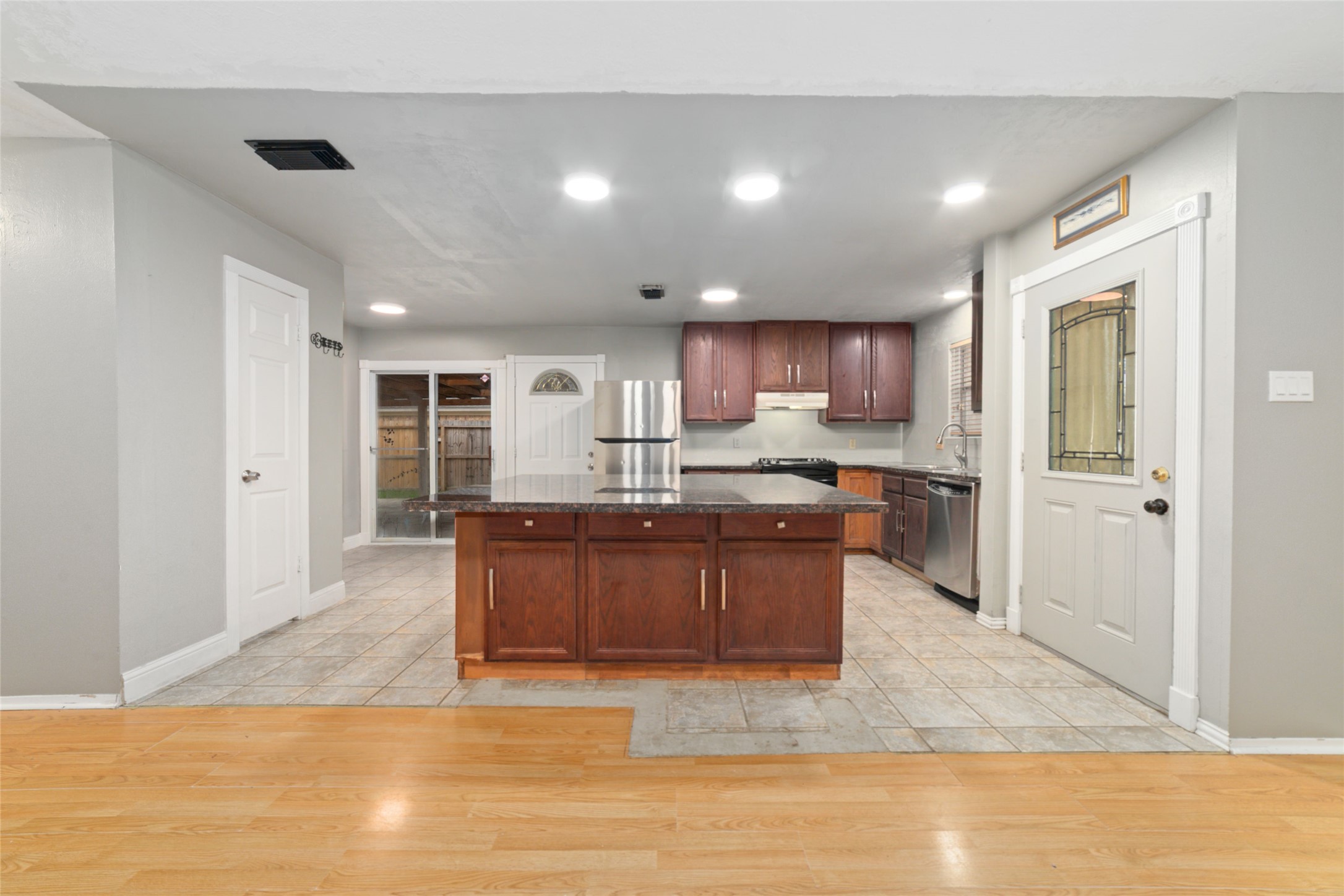 2318 Gum Spring Lane Spring, TX 77373 - Photo 8 of 25 a open kitchen with granite countertop a refrigerator and a sink