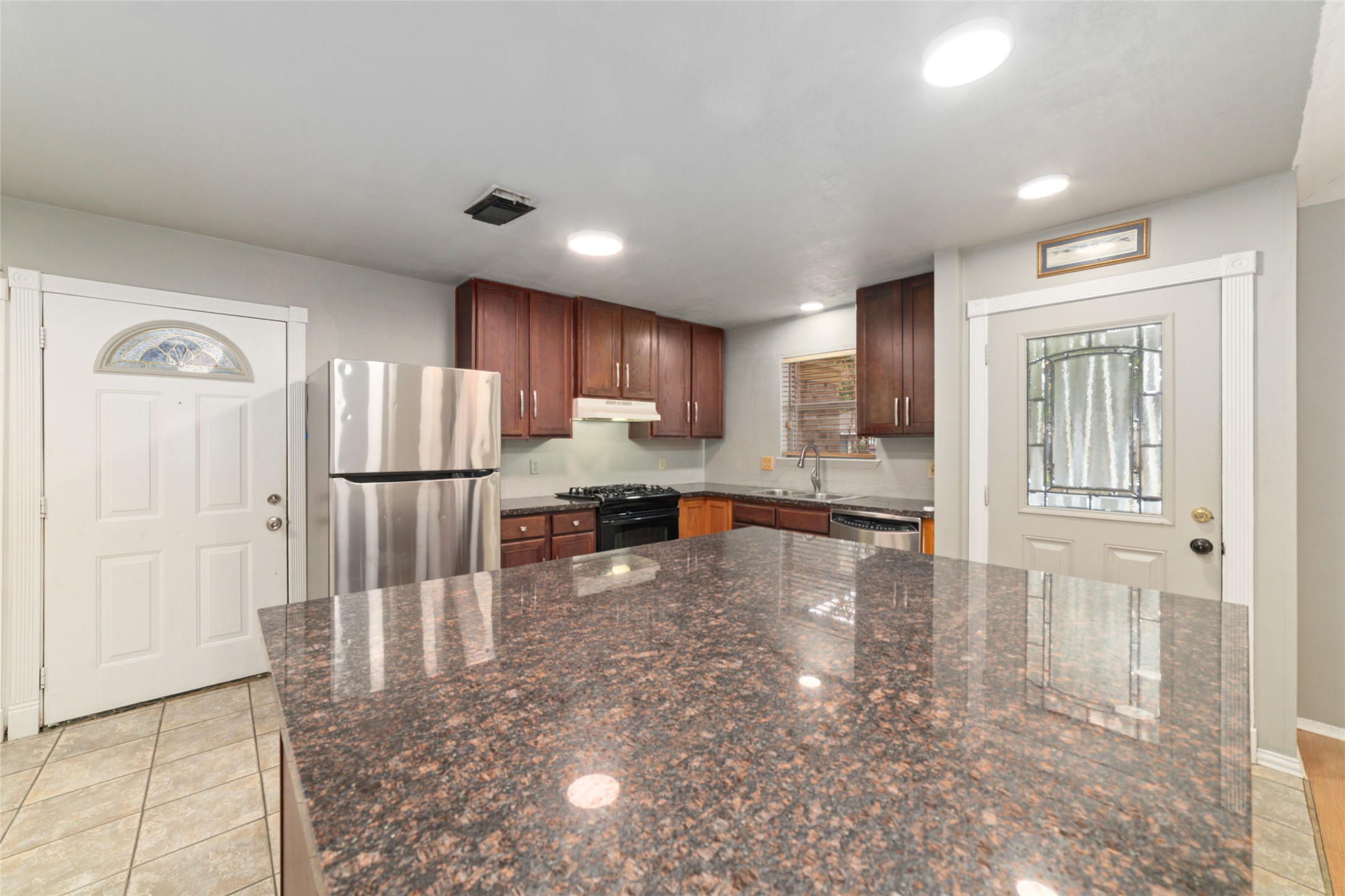 2318 Gum Spring Lane Spring, TX 77373 - Photo 9 of 25 a kitchen with granite countertop a refrigerator and a sink