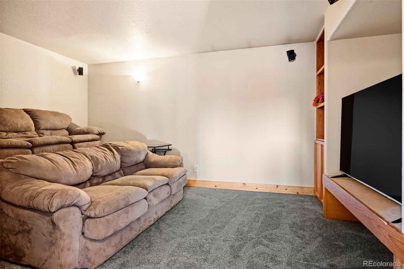 412 Evergreen Road Black Hawk, CO 80422 - Photo 36 of 48 a living room with furniture and a flat screen tv