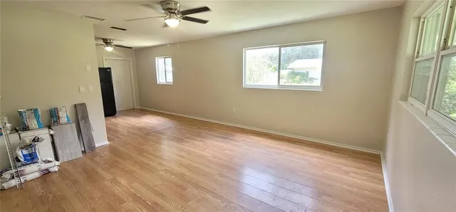 wooden floor in an empty room with a window