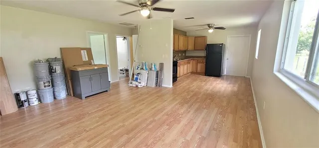 a view of a kitchen with a sink a refrigerator and window
