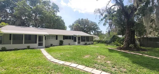 a view of a house with a yard porch and sitting area