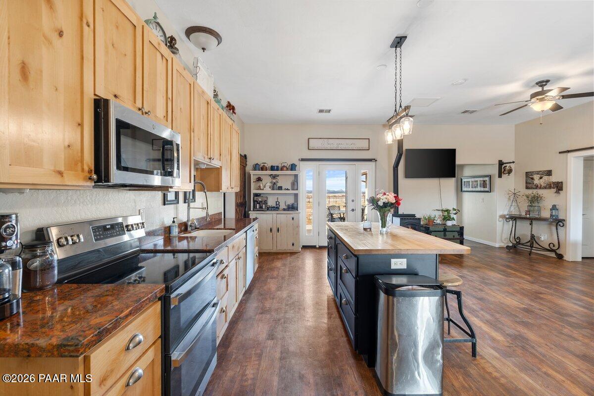 5757 East Longhorn Road Chino Valley, AZ 86323 - Photo 11 of 34 a kitchen with counter top space appliances and wooden floor