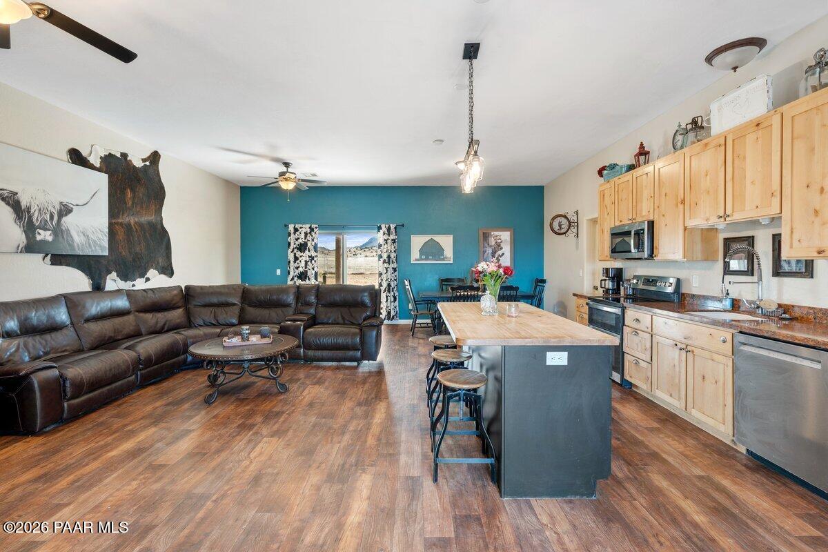 5757 East Longhorn Road Chino Valley, AZ 86323 - Photo 13 of 34 a living room with lots of furniture kitchen view and a wooden floor