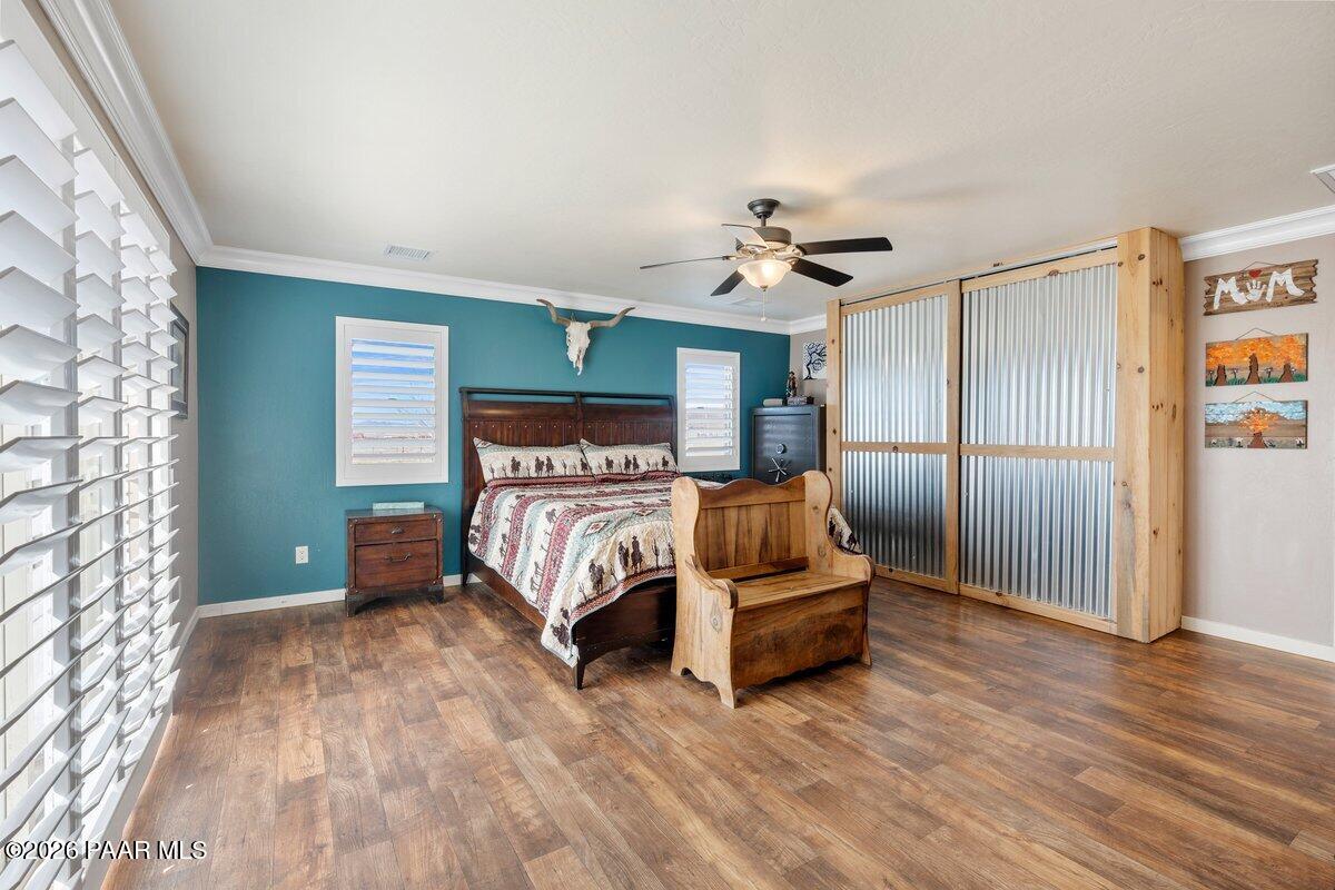 5757 East Longhorn Road Chino Valley, AZ 86323 - Photo 15 of 34 a bedroom with a bed and a ceiling fan