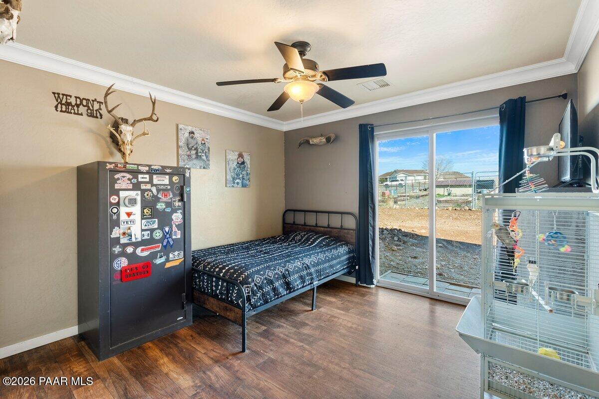 5757 East Longhorn Road Chino Valley, AZ 86323 - Photo 19 of 34 a bedroom with a bed and a chandelier
