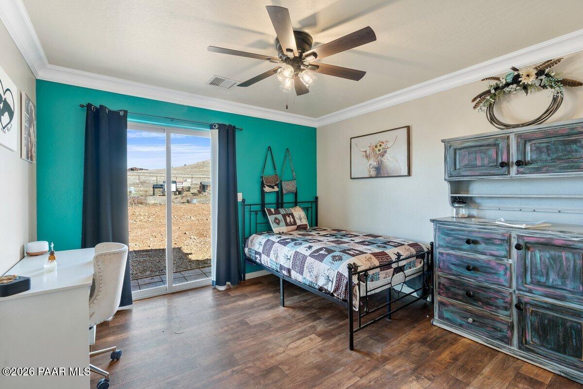5757 East Longhorn Road Chino Valley, AZ 86323 - Photo 20 of 34 a bedroom with a bed and wooden floor